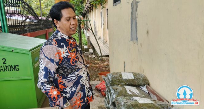 
 Kepala SMP Negeri 2 Tenggarong, Yunus, menunjukkan hasil olahan sampah organik berupa pupuk kompos.